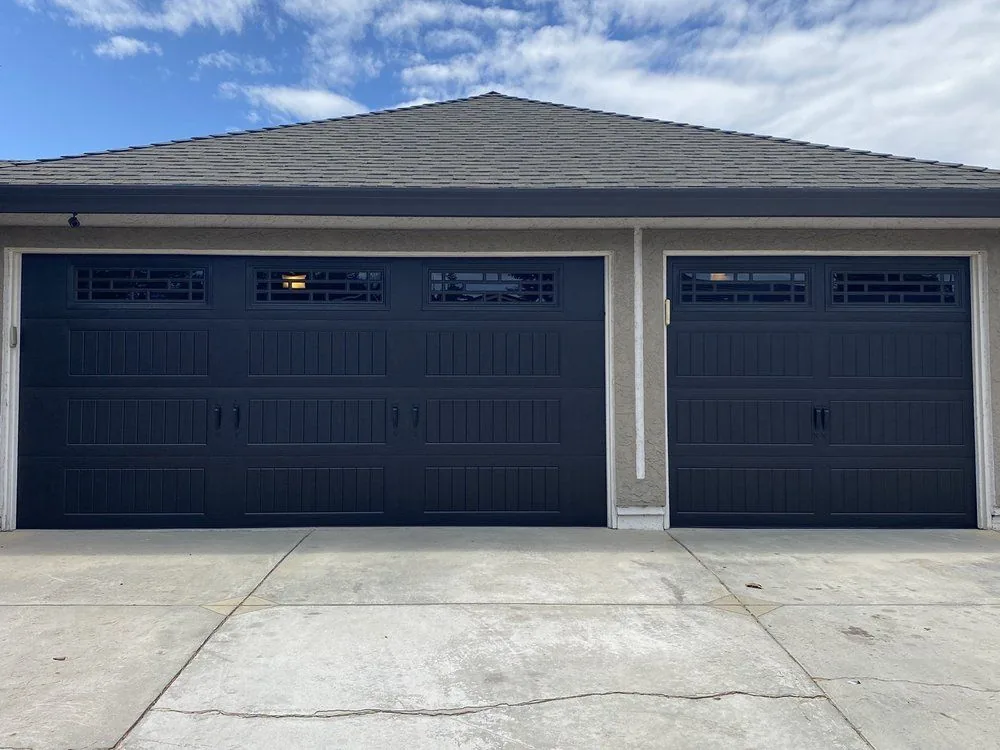 Black replacement double garage door in Centennial