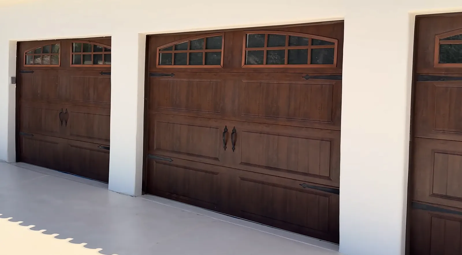 Black custom residential garage doors with contemporary panel design