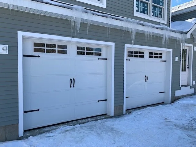 Garage door installation Adams County white carriage-style double garage doors in winter
