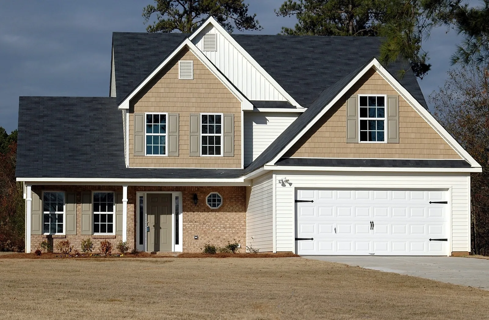 Garage door installation Adams County white traditional double garage door on a two-story home