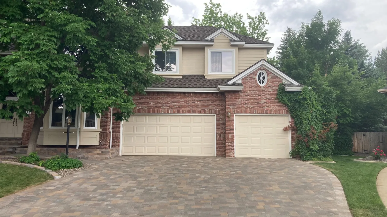 Garage door installation Arapahoe County cream raised-panel double and single garage doors