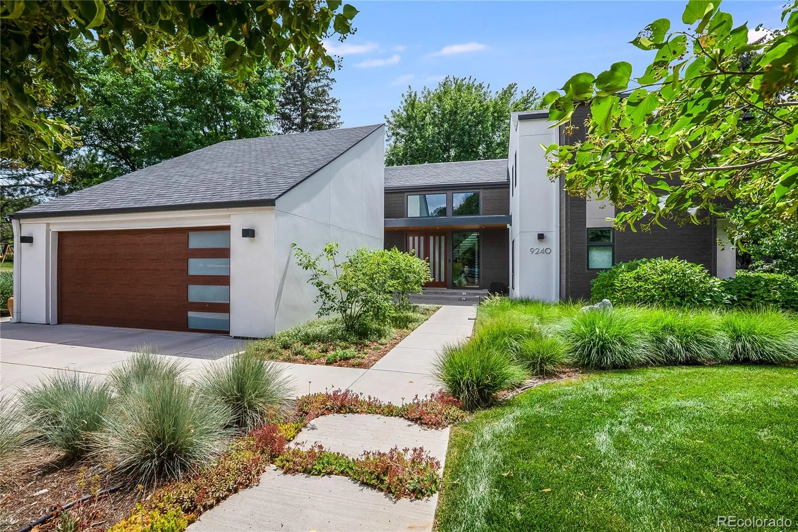 Modern wood double garage door with vertical windows in Aurora