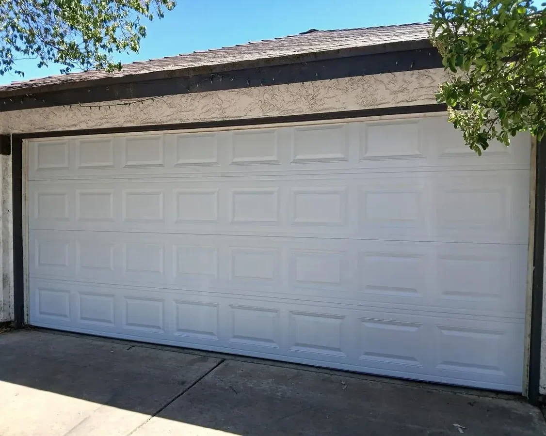 Steel raised-panel double garage door in Centennial, CO