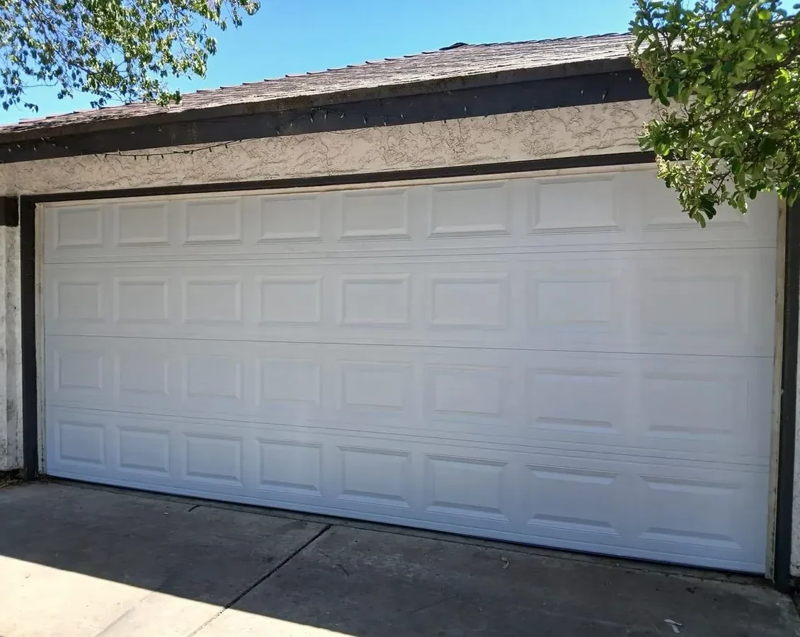 Steel raised-panel double garage door in Denver, CO