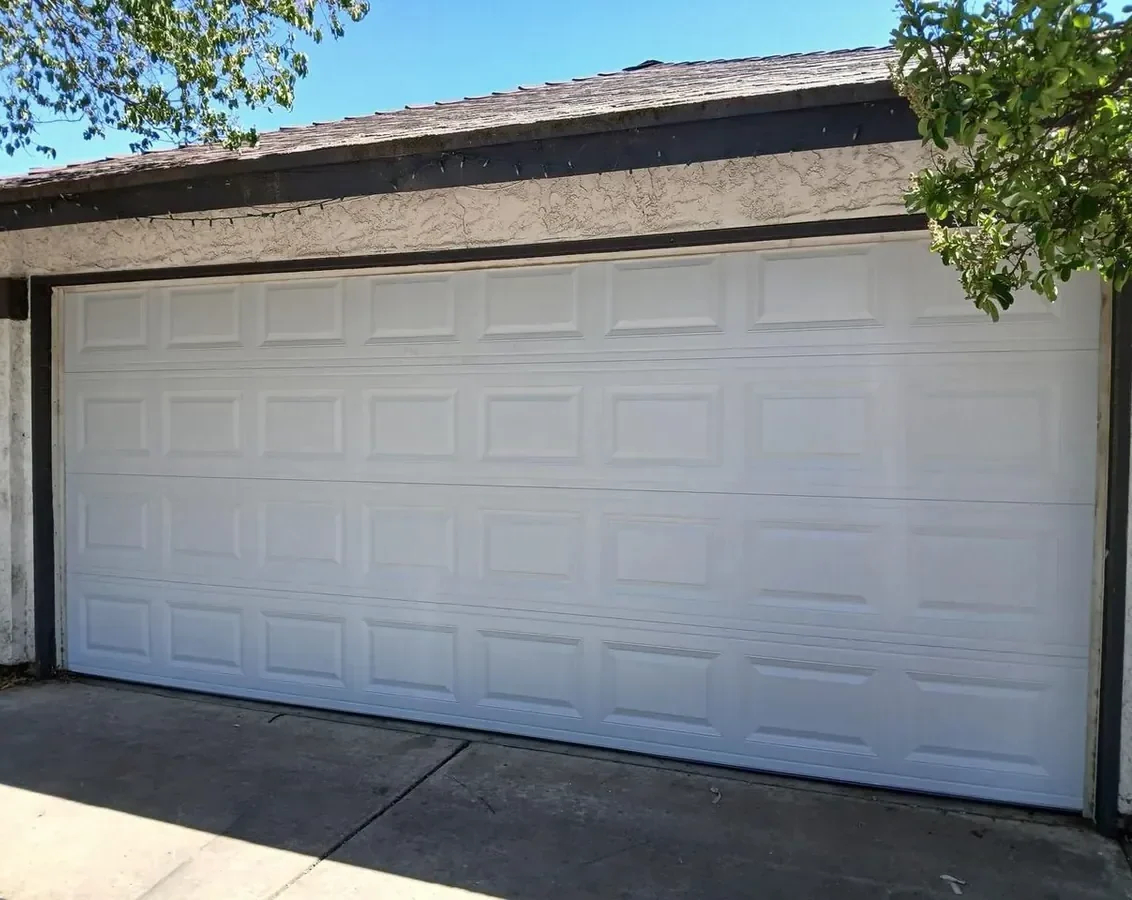 Steel raised-panel double garage door in Littleton, CO