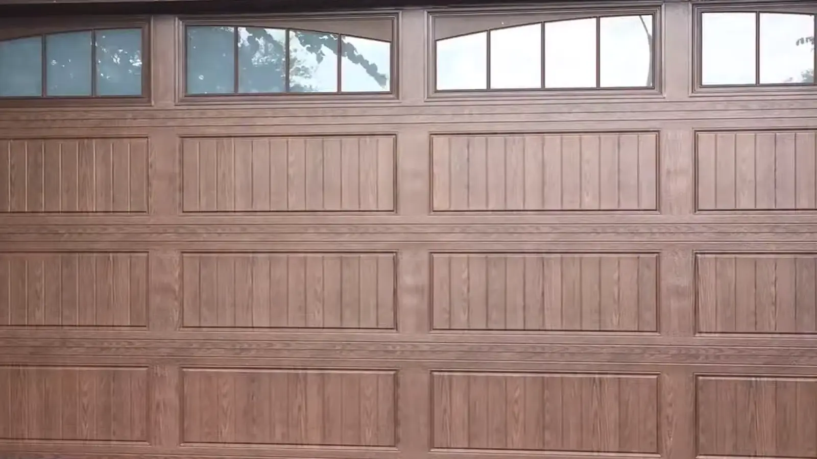 Garage door installation Lone Tree technician installing a wood-look garage door