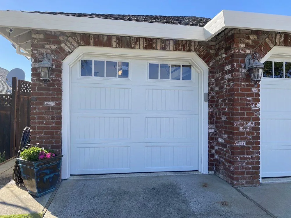Garage door installation Lone Tree white carriage-style single garage door with decorative windows
