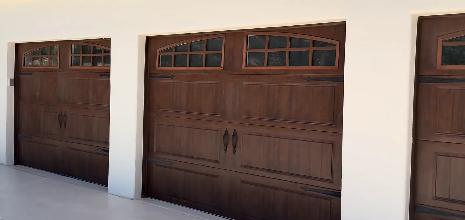 White double residential garage doors with traditional raised panels